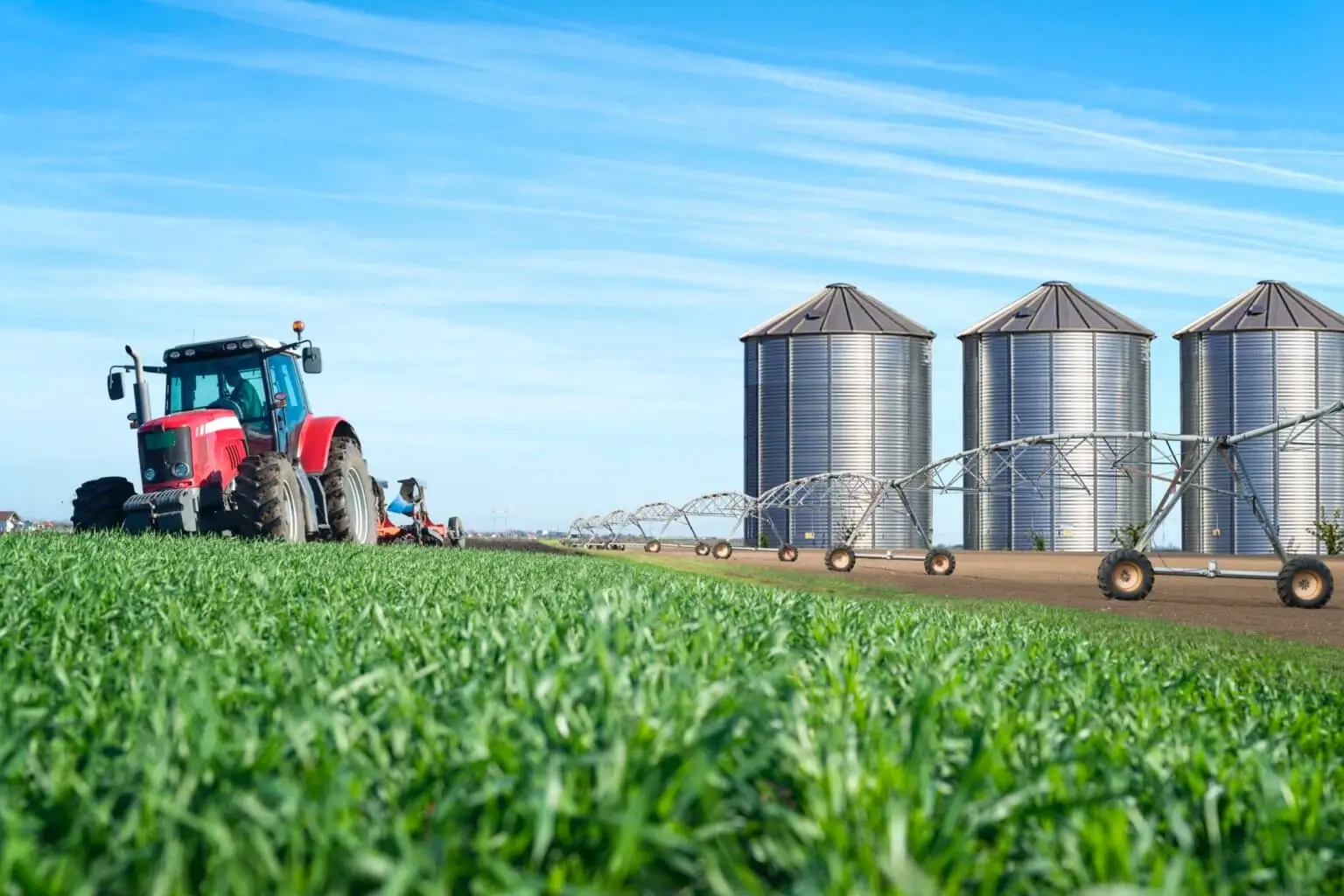 Agriculture and food production concept with tractor machine silos