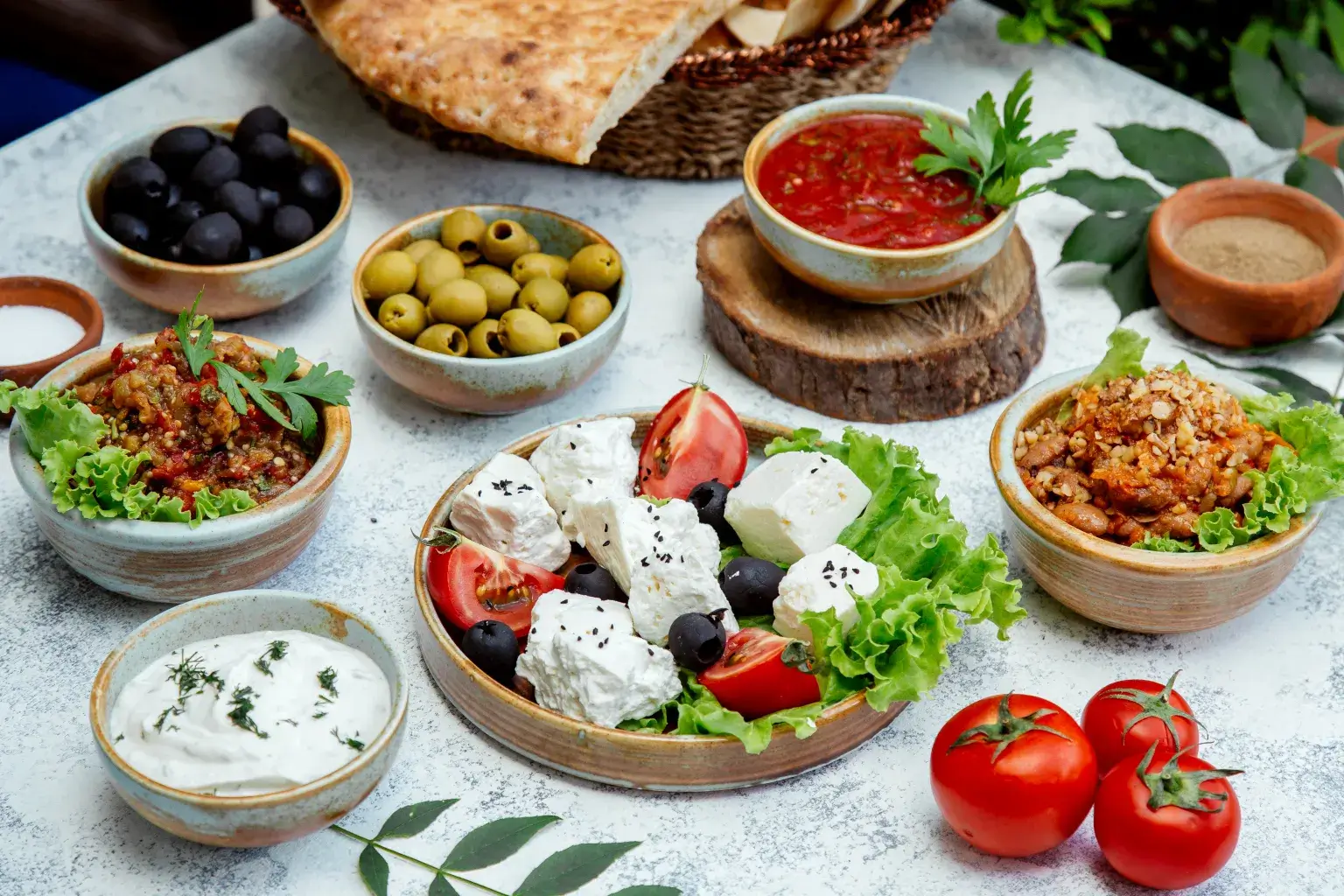 outdoor lunch with salads olives bread